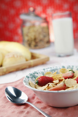 Breakfast cereal with milk in the background
