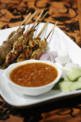 Satay with peanut gravy and slivers of onions and cucumbers