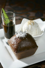 Steamed palm sugar sponge cake served with a shot of caramelized palm sugar and a scoop of coconut ice-cream