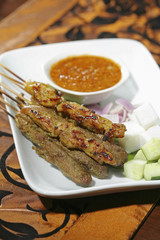 Satay with peanut gravy and slivers of onions and cucumbers