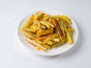 Appetizing fried potatoes on a white plate. Side view