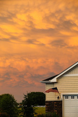 Sky on fire with flag blowing in the wind