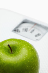 Green apple on a weighing scale