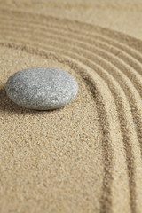 Fototapeta na wymiar Single stone placed on sand