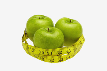Measuring tape wound around three apples