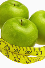 Measuring tape wound around three apples
