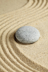 Fototapeta na wymiar Stone on rippled sand