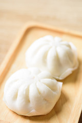 Steamed buns stuffed with minced pork on plate, Asian food