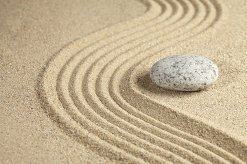 Fototapeta na wymiar A stone place beside a rippled surface sand