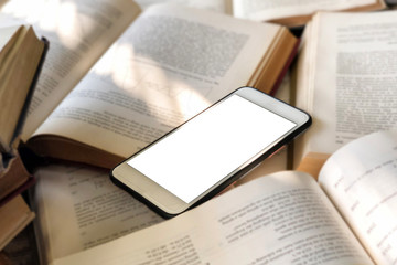 Books and smartphone in library