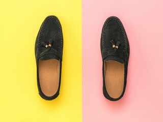 Stylish men's suede shoes on a red and yellow background.