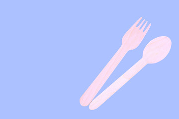 Wooden spoon and fork isolated on blue background, Isolated Wooden Kitchen Utensils.