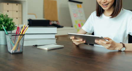 Closeup of woman hand holding digital tablet on the home.