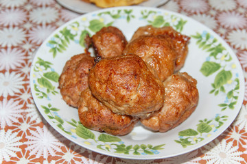 plate on the table with fried cutlets   