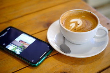 drinks coffee in a cafe