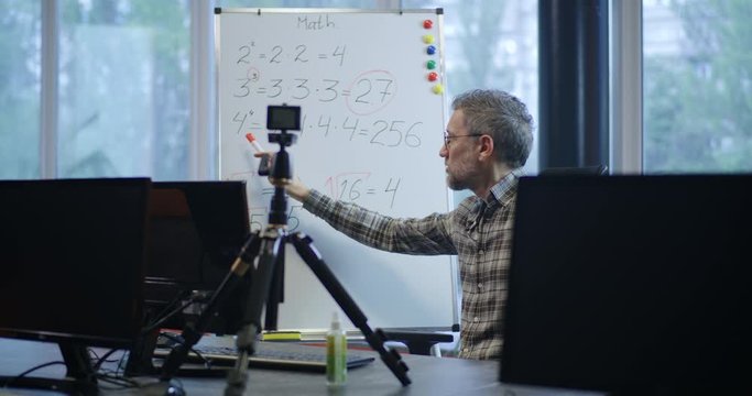 Teacher explaining math to camera