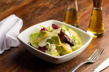 Fresh salad spring with lettuce and slices of pears and blue cheese