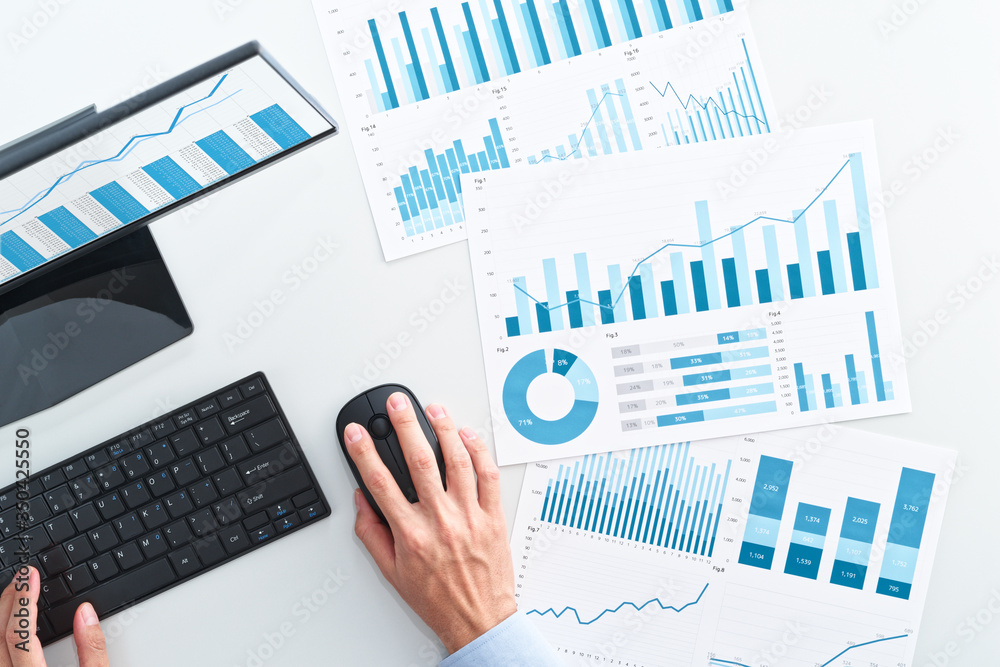Poster Top view of business man using spreadsheet. Many business analysis reports and desktop computer.