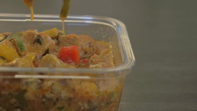 Close Up of Metal Silver Spoon Scooping Food from Glass Container, Slow Motion