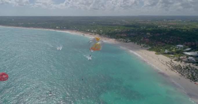 Parasailing over sea of Punta Cana beach, Dominican Republic. Aerial