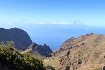 Fototapeta na wymiar Cliffs and rocks panorama with Atlantic Ocean and La Gomera in the background on Canary Island Tenerife, Spain