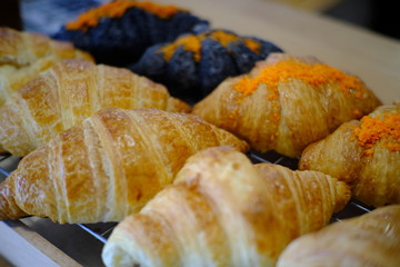 Fresh tasty croissants as background, closeup. French pastry 
