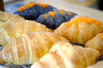 Fresh tasty croissants as background, closeup. French pastry 