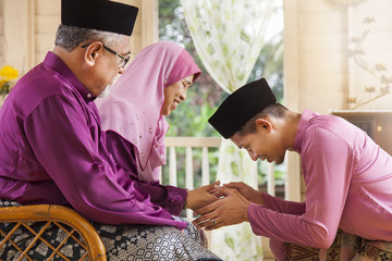 Traditional act of respect in Muslim family on Eid al-Fitr