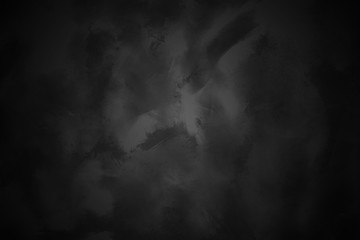 Black concrete background wall. Old surfaces that have scratches and cracks.