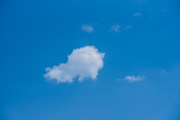 Fototapeta na wymiar A white cloud in a blue sky. Sky landscape.