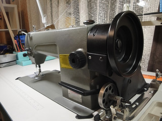  Industrial sewing machine in a seamstress house. Metal sewing machine close-up