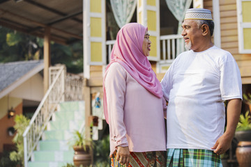 Fototapeta premium Senior couple in front of wooden house