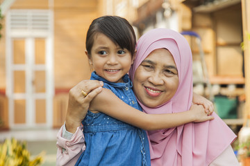 Grandmother and granddaughter hugging