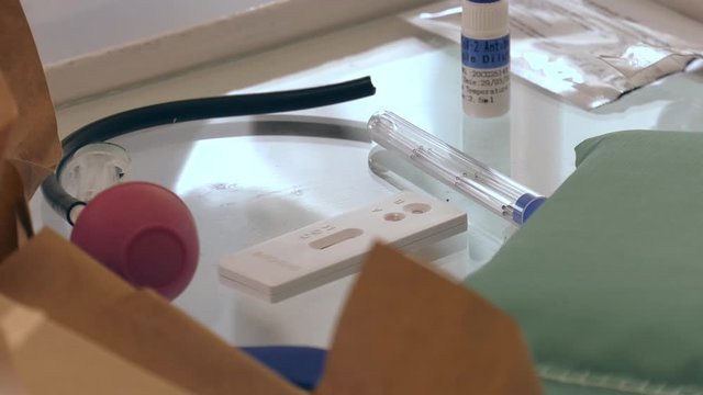 The reagent is added to the blood. Doctor making a test kit for viral disease COVID-19 2019-nCoV. Laboratory card kit test for SARS-CoV-2 virus coronavirus. COVID-19 rapid test. Positive COVID-19.
 