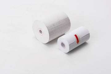 A roll of thermal printing paper used at a supermarket checkout is on a white background