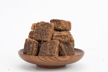 A plate of brown sugar on a white background