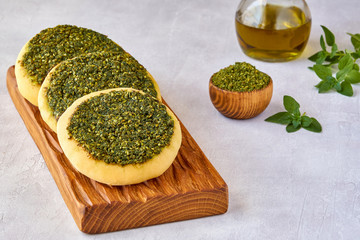 Zaatar manakeesh on wooden board  . Close up, copy space
