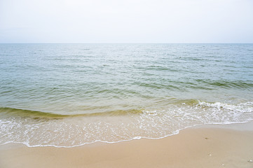 Fototapeta na wymiar Soft wave with blue ocean on sandy beach.