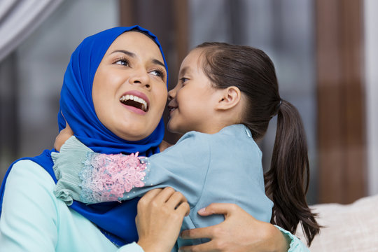 Muslim girl kissing her mother