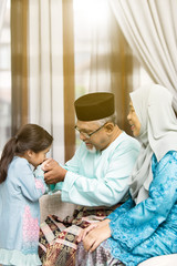 Traditional act of respect in Muslim family on Eid al-Fitr