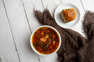 Russian borscht with sorrel and fresh garlic knots pamopushkas. hot soup with egg version. Sorrel soup. 