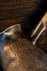 Old copper turk for making coffee. background. macro-photo. side view. part of a metal product