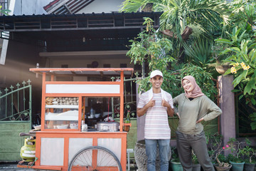 muslim woman buy bakso from street food vendor