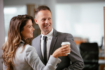 Colleagues in office. Businesswoman and businessman discussing work in office