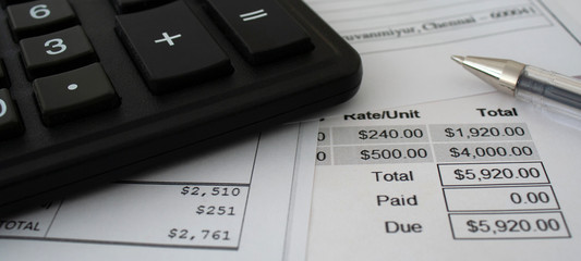 Macro shot of calculator , pen and documents with figures. Web banner for the site. Accounting services for business. Counting finance and wages. Accounting for income and expenses. Close up photo.