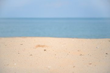 Soft wave with blue ocean on sandy beach.