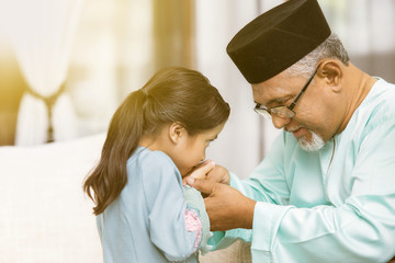 Traditional act of respect in Muslim family on Eid al-Fitr