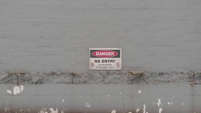 Danger, No Entry Sign On An Old Building For Demolition In Dublin, Ireland - zoom-in shot