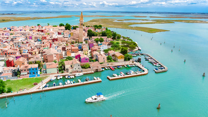 Aerial view of colorful Burano island in Venetian lagoon sea from above, Italy  © Iuliia Sokolovska