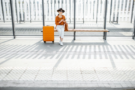 Female traveler at the public transport stop